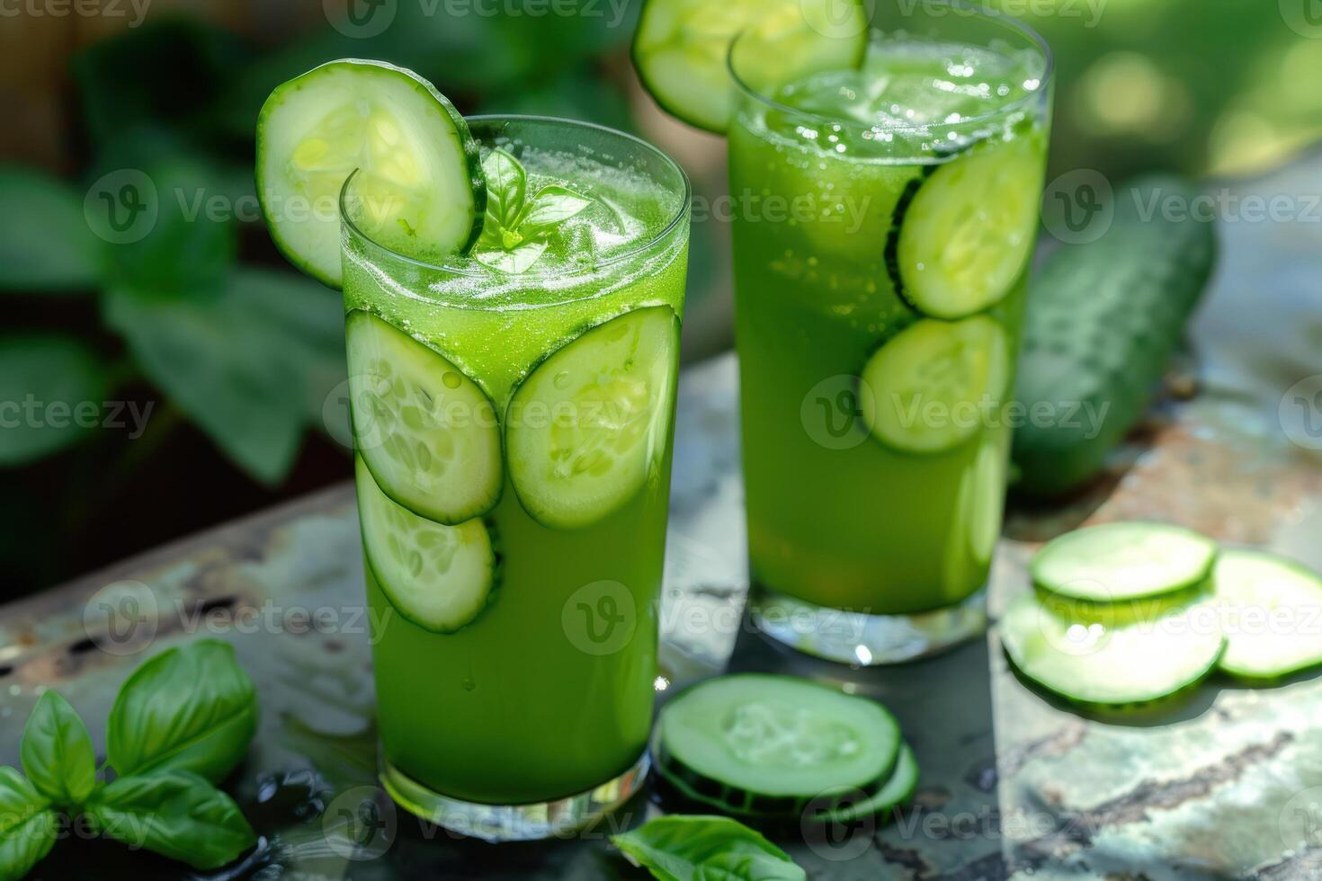 Refreshing cucumber basil juice in glasses outdoors photo