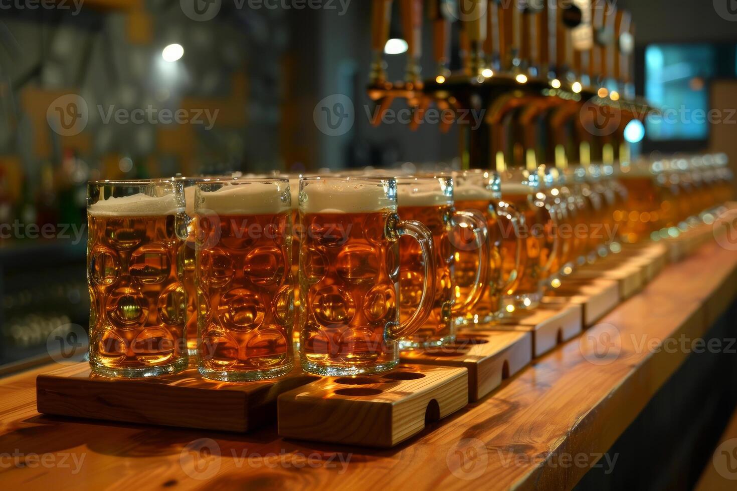Row of full beer mugs sitting on bar with taps in background photo