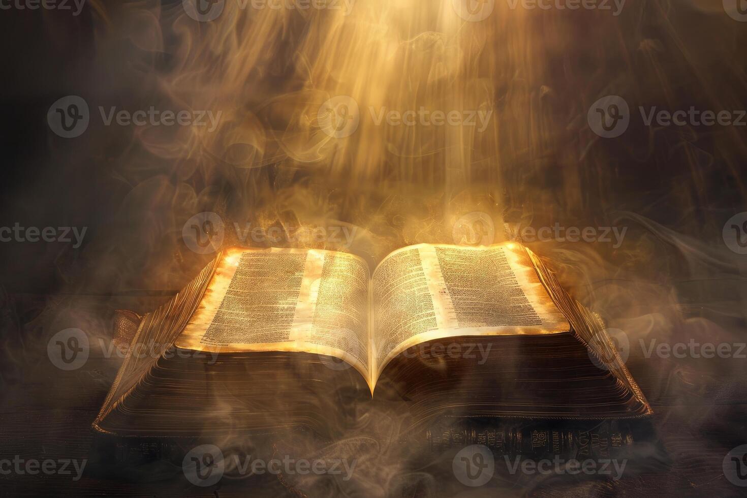 Open ancient book with magical glowing light shining from inside surrounded by smoke photo