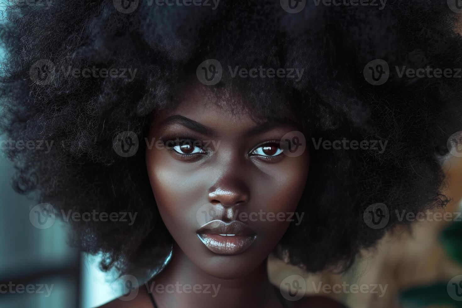 Beautiful black model with afro hairstyle posing in front of a blurred background photo