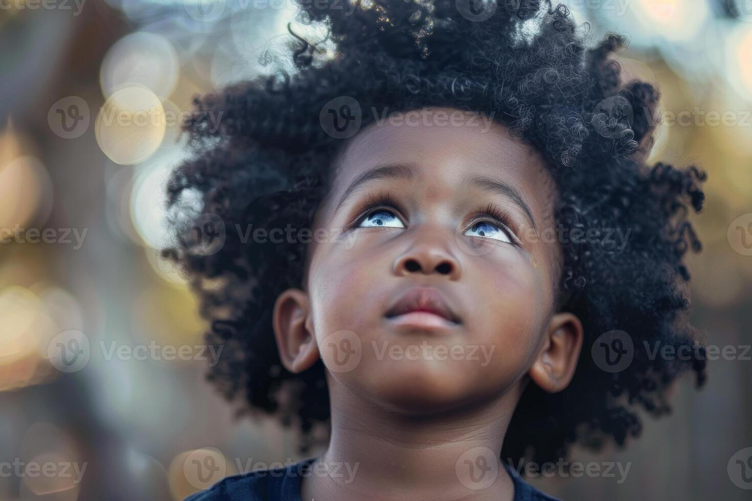 Young child is looking up with a thoughtful expression photo