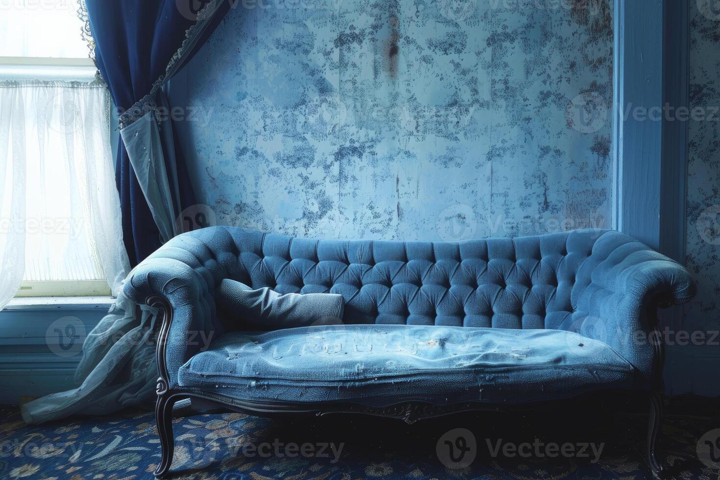 Old blue sofa sitting in front of a window in an abandoned house photo
