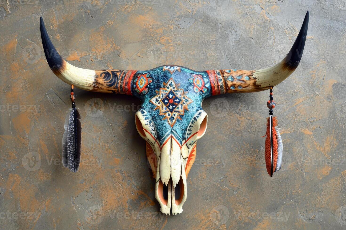 Decorated animal skull with feathers hanging on a textured wall photo