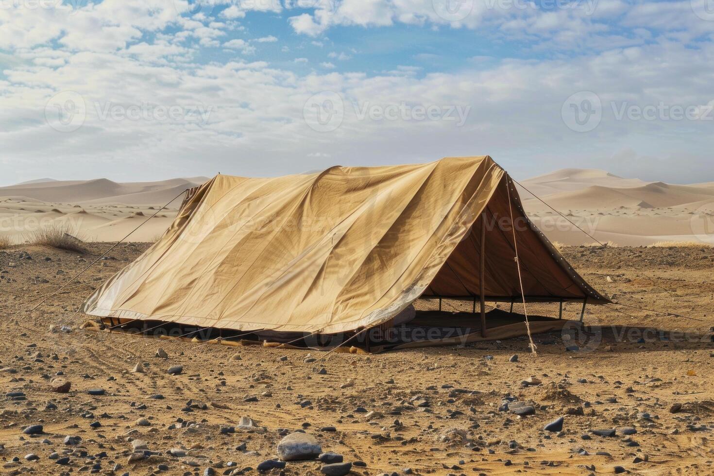 Large tent standing in the middle of the desert on a sunny day photo