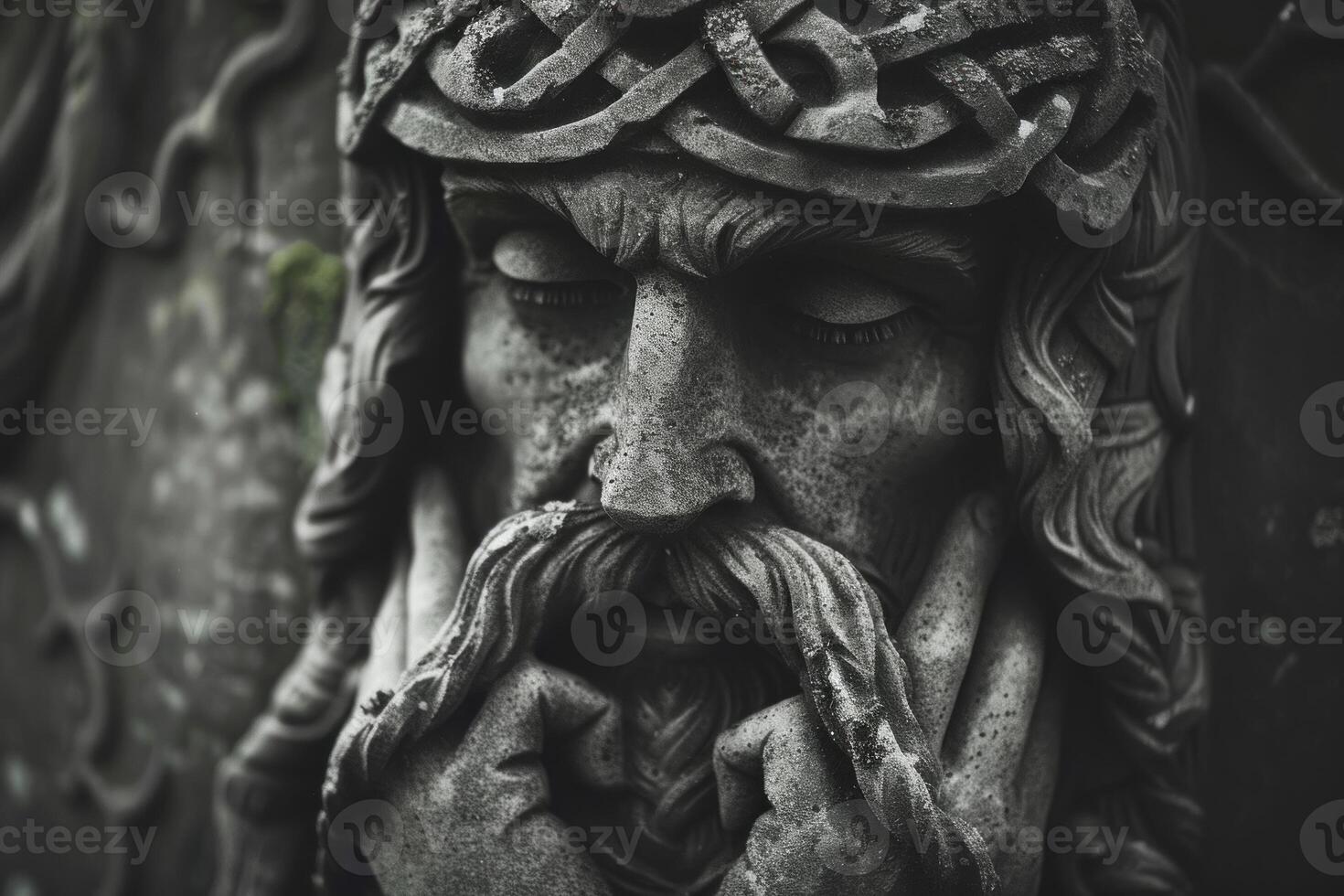 Ancient stone statue of jesus christ wearing crown of thorns photo