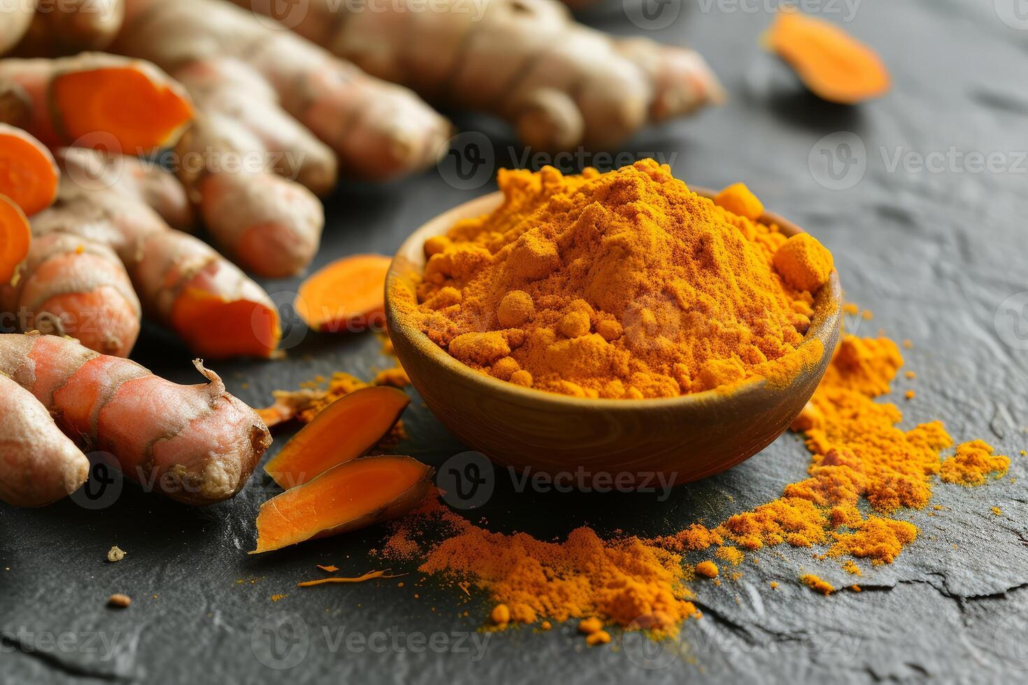 Fresh turmeric and powder on dark background photo