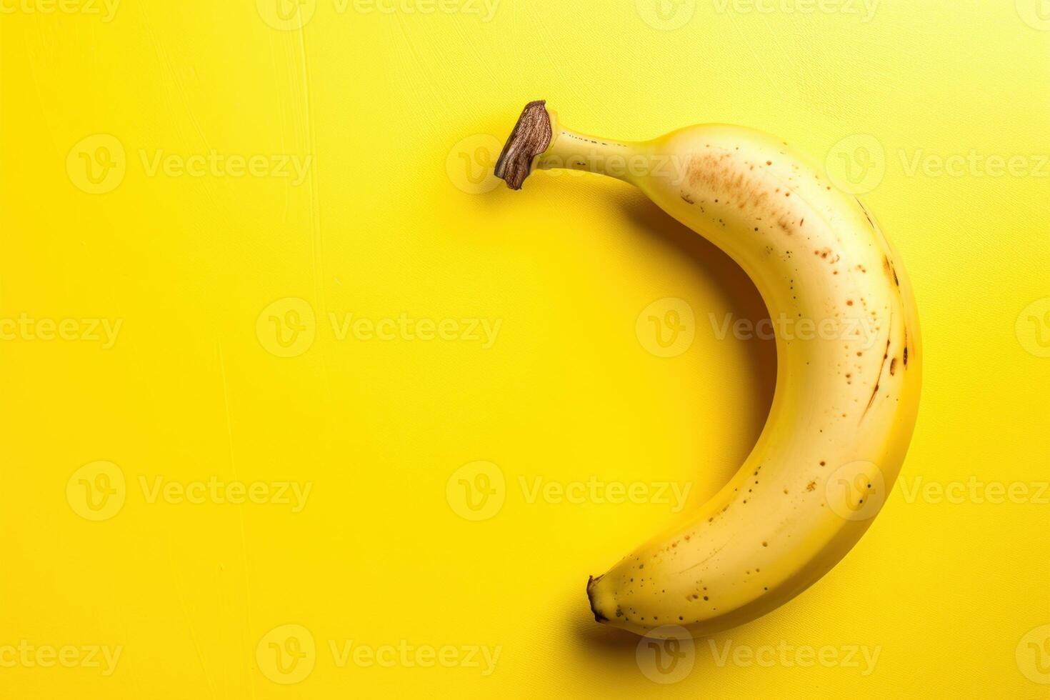 Ripe banana on yellow background photo