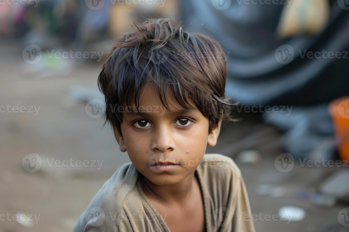 Poignant portrait of a young boy in an urban setting photo