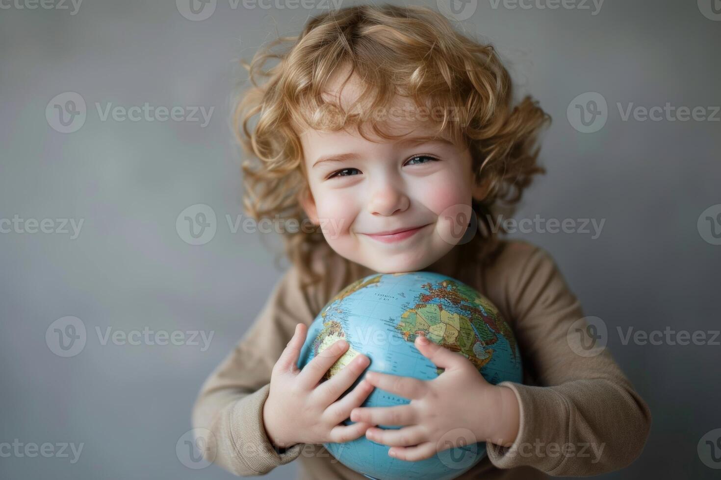 Happy child holding a globe photo