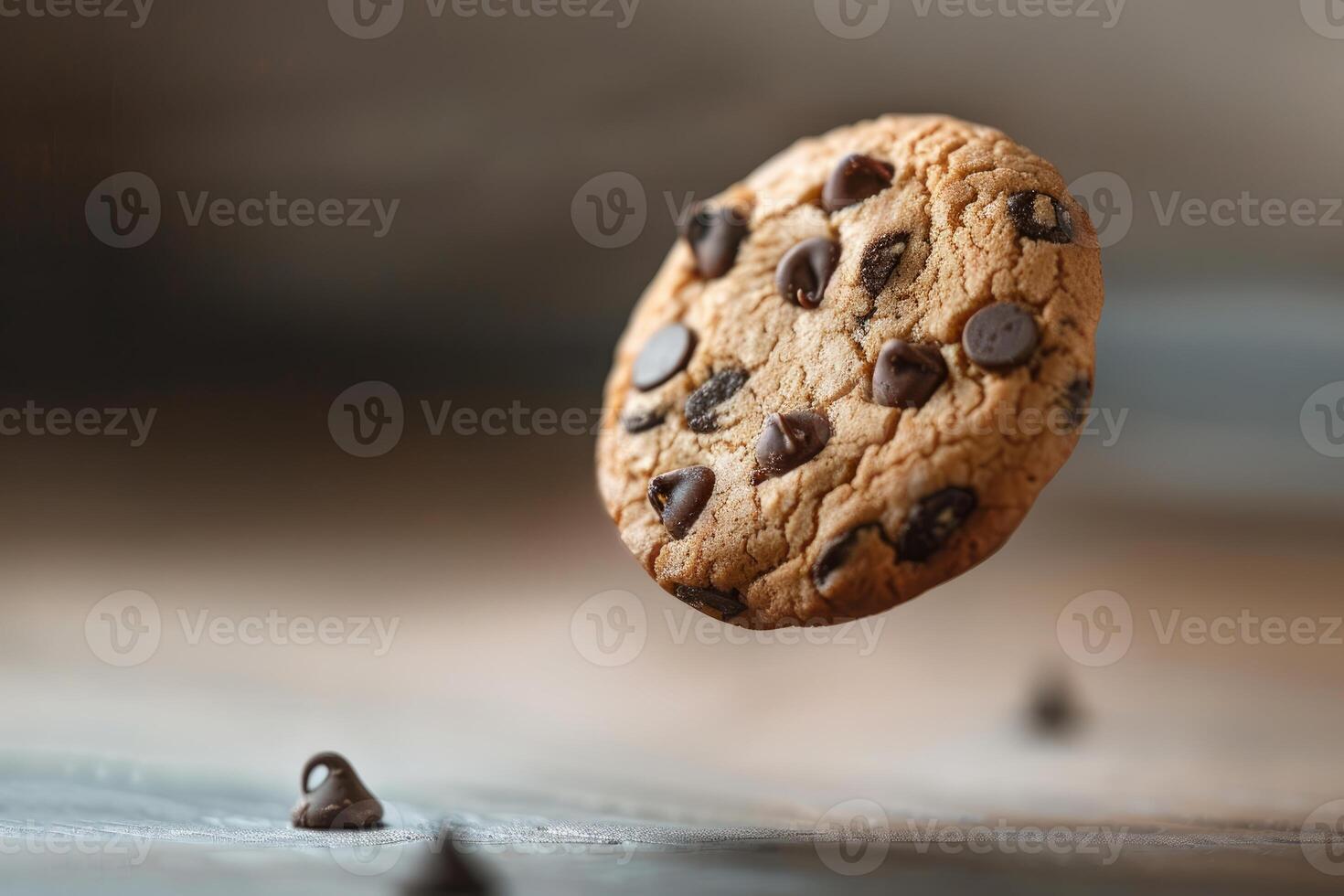 Delicious chocolate chip cookie appears to float above a wooden surface photo