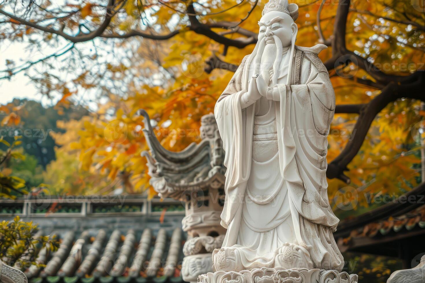 Ancient sage statue in autumn park photo