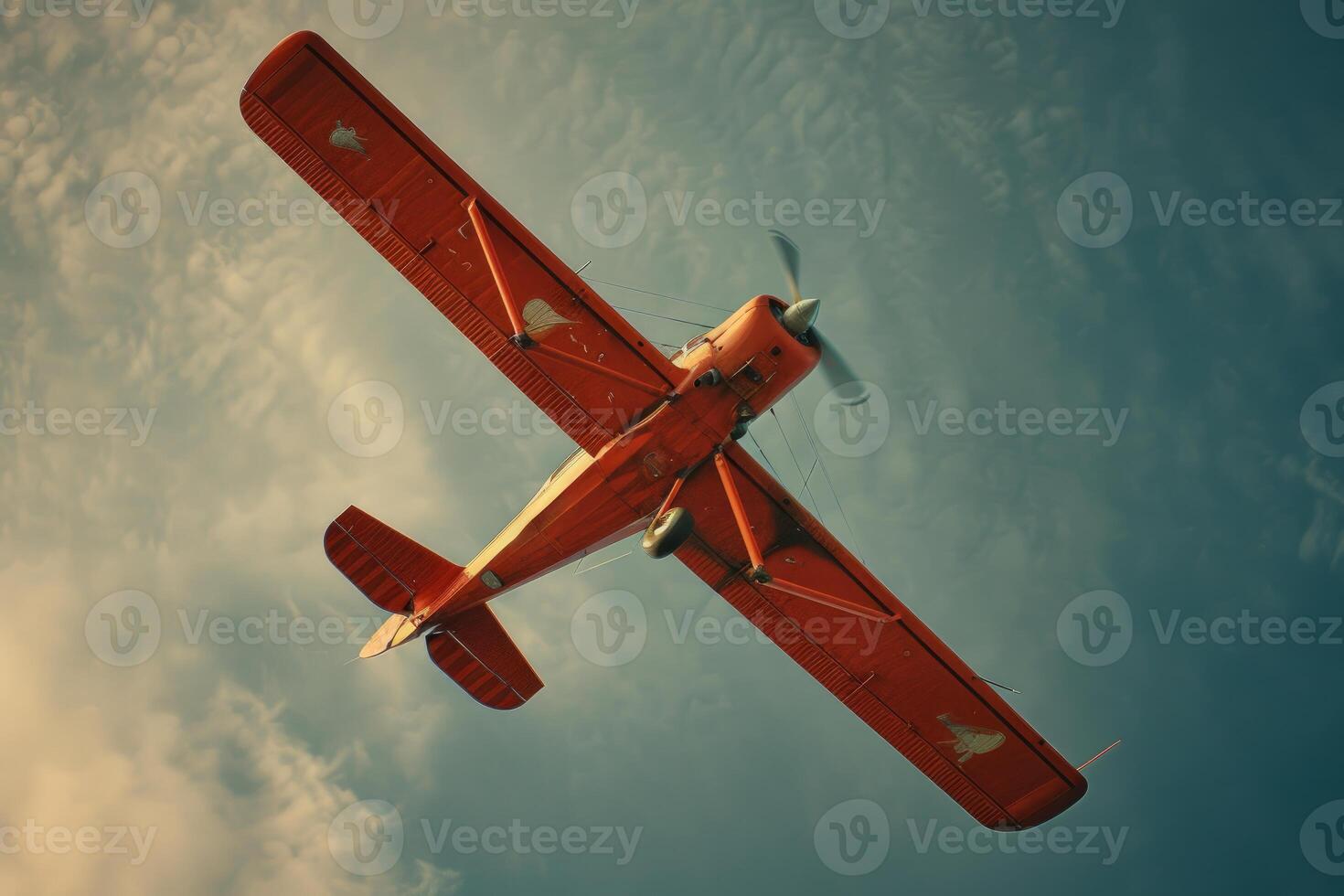 Vintage biplane soaring against a cloudy sky photo
