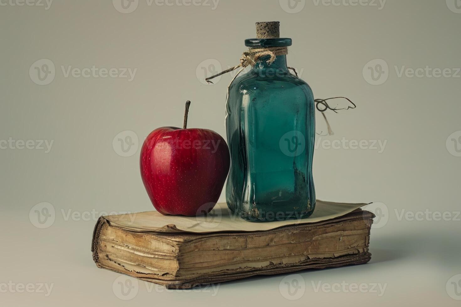 Vintage book with apple and ink bottle photo