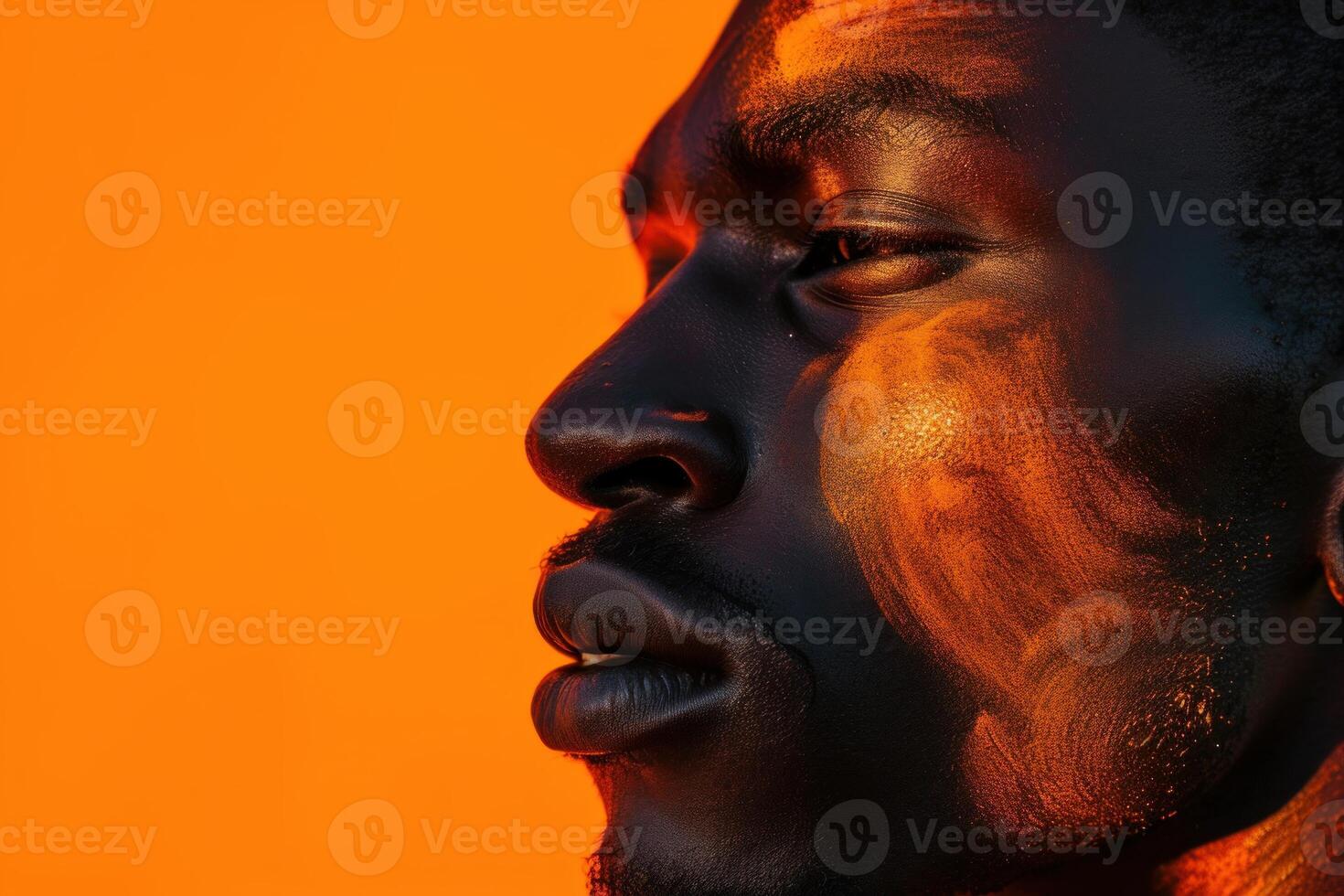 Intense portrait of a man with orange backdrop photo