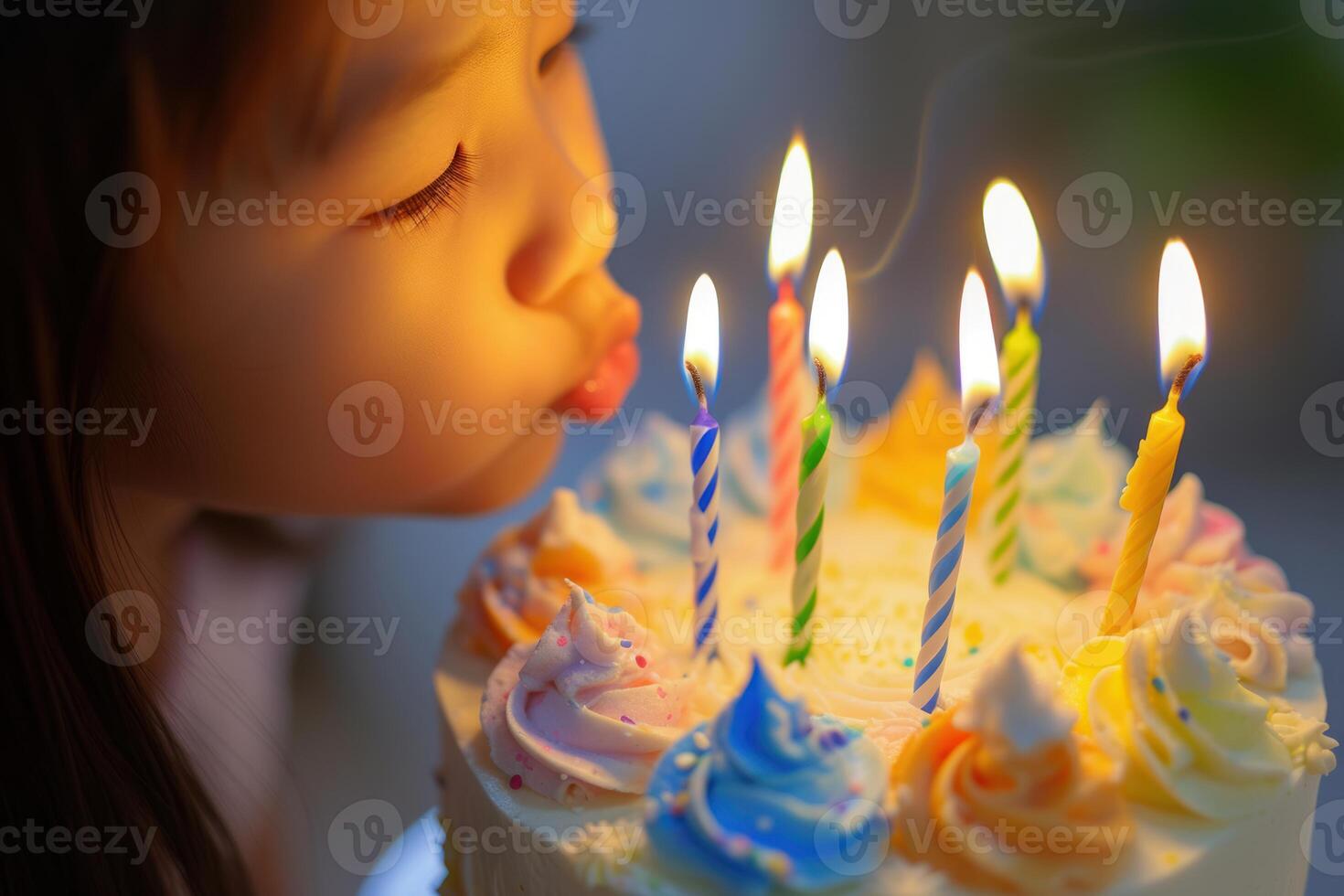 Little girl blowing out birthday candles photo