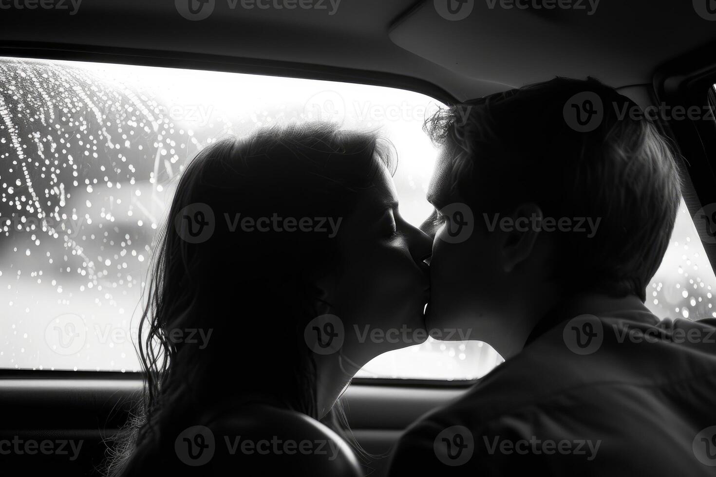 Intimate couple kissing in car on rainy day photo