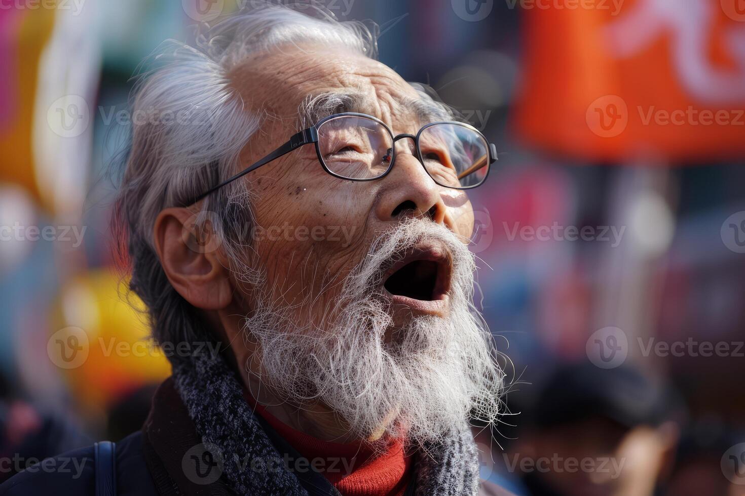 Elderly man with glasses in thoughtful expression photo