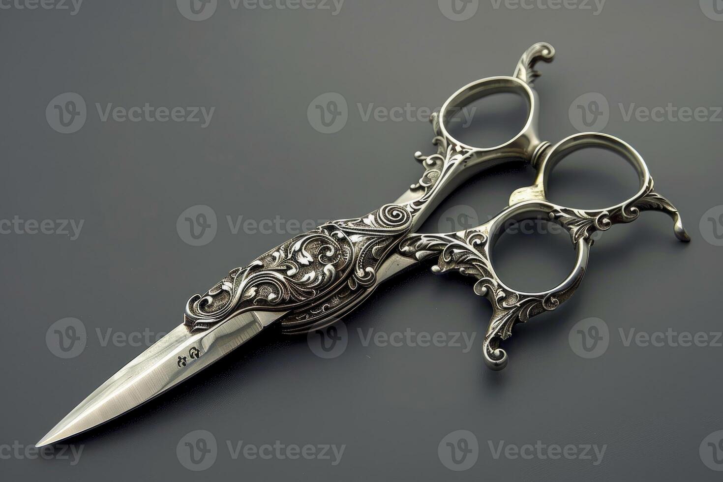 Ornate vintage silver scissors on dark background photo