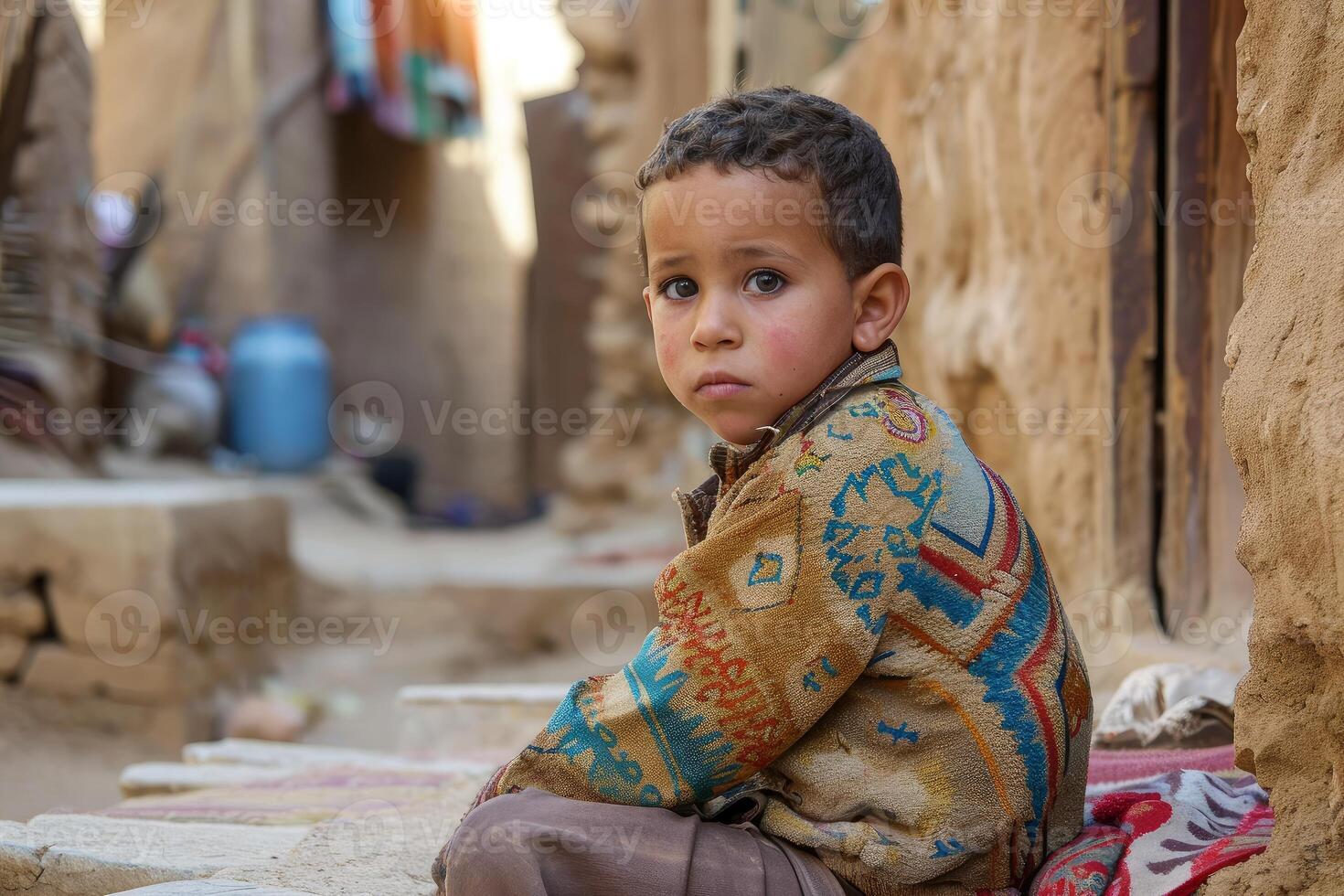 Young boy seated in alleyway photo