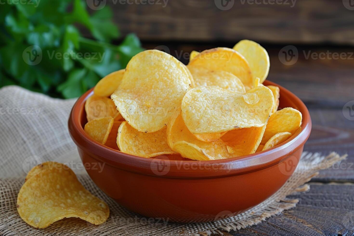 Crispy golden potato chips in bowl photo