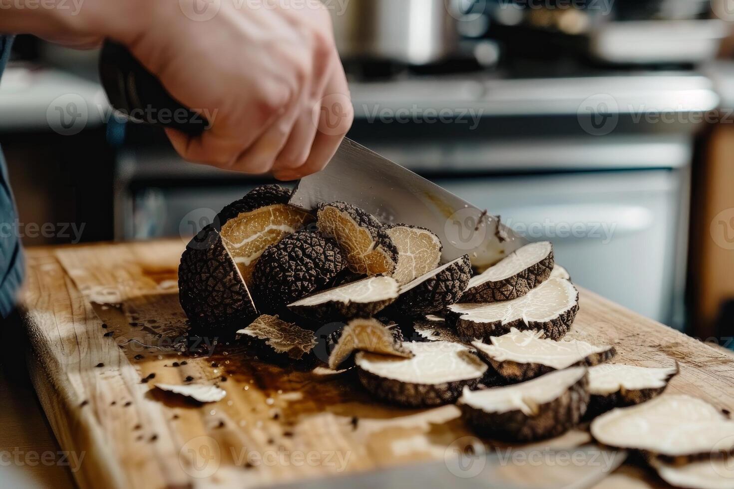 Master chef slicing black truffles on wooden board photo