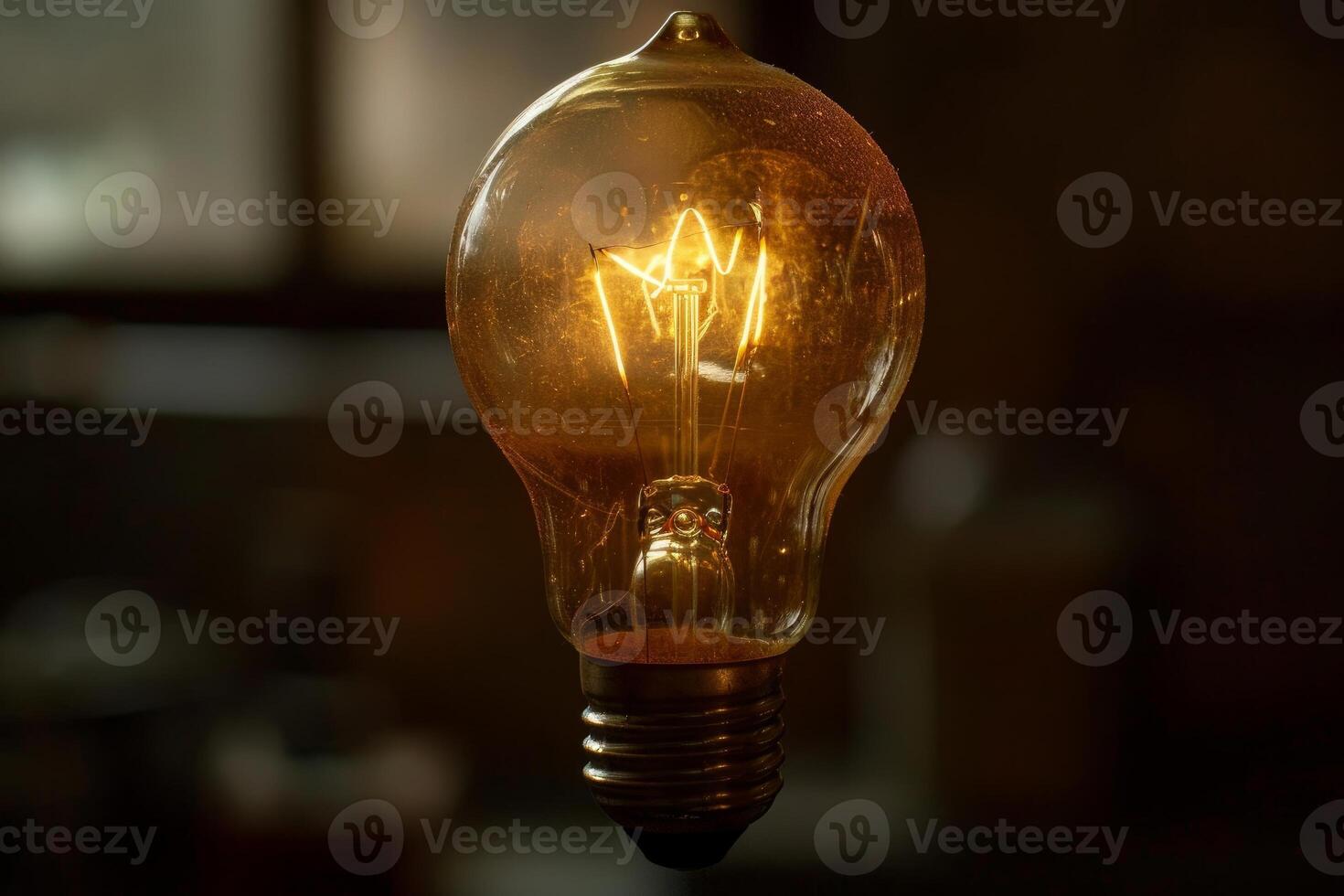 Closeup image showcasing the details of a lit incandescent light bulb on a dark background photo