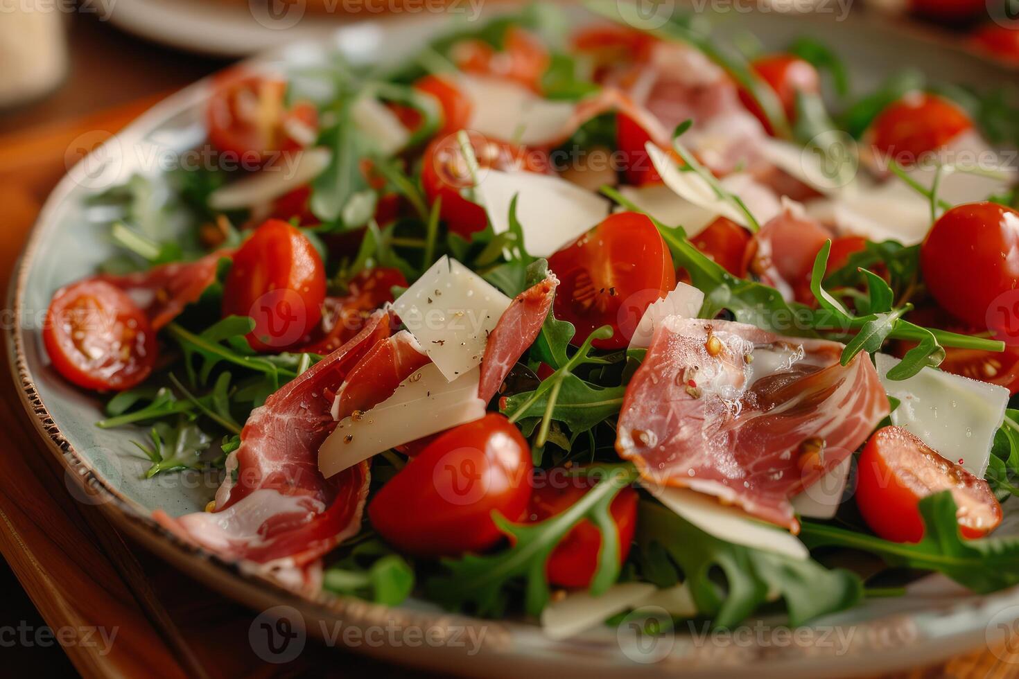 Fresh arugula salad with prosciutto and cherry tomatoes photo