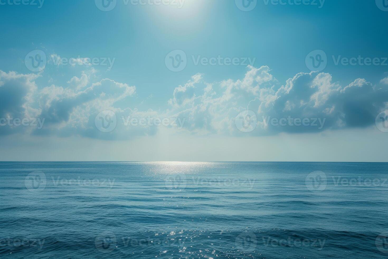 Serene ocean under sunlit skies photo