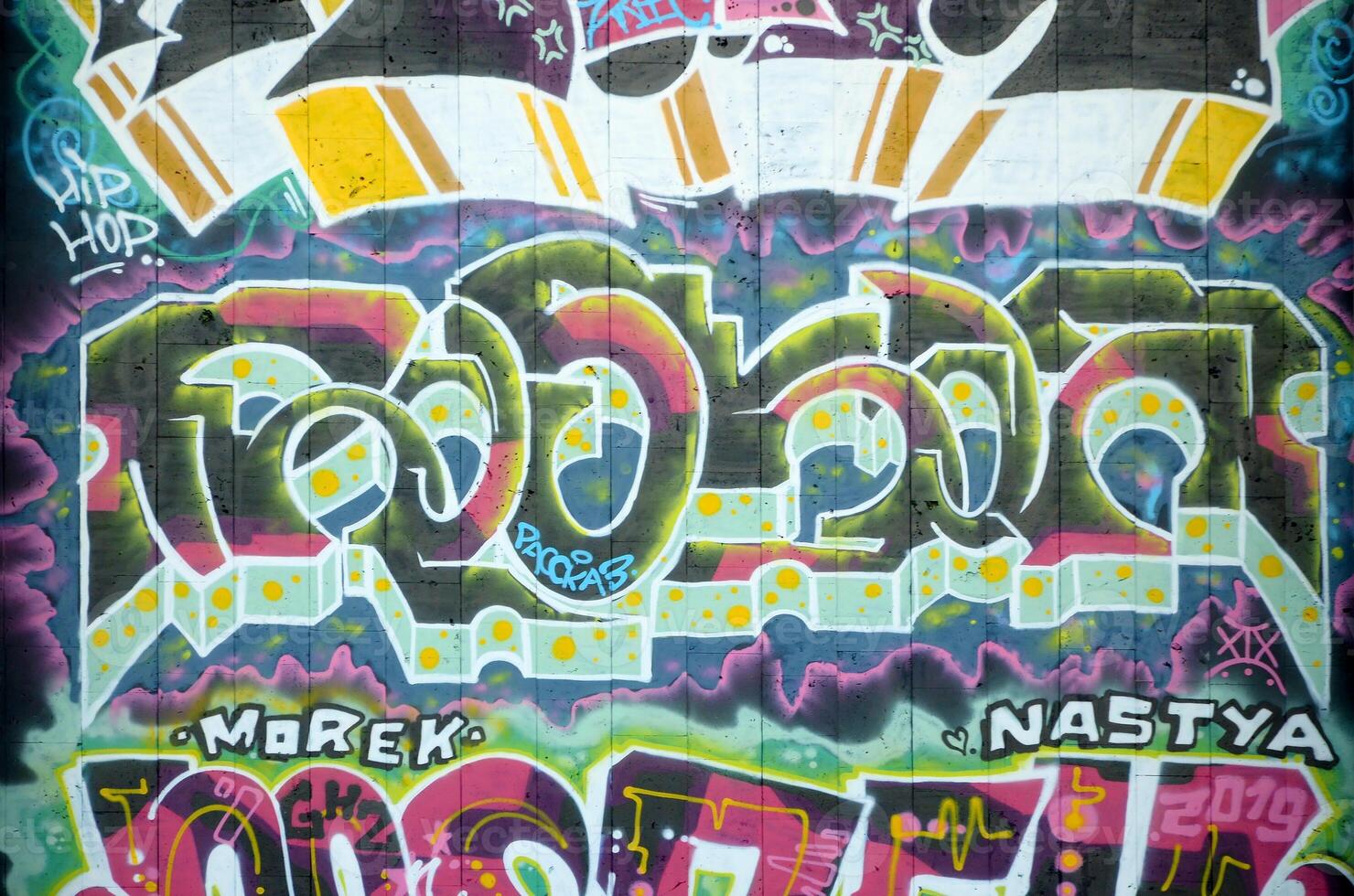 Colorful background of graffiti painting artwork with bright aerosol outlines on wall. Old school street art piece made with aerosol spray paint cans. Contemporary youth culture photo