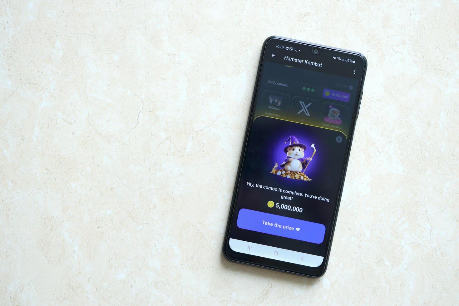 KYIV, UKRAINE - APRIL 20, 2024 Hamster Kombat telegram bot on smartphone screen. Hamster Kombat is a viral Telegram crypto game for earn HMSTR tokens by managing virtual crypto exchange photo