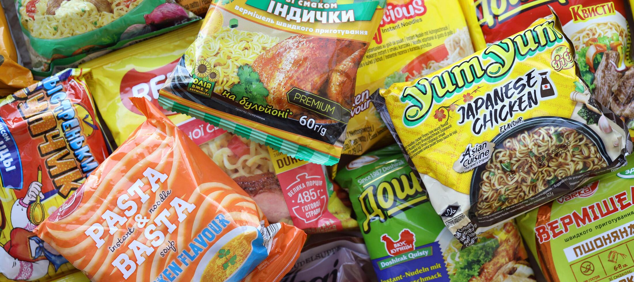KYIV, UKRAINE - APRIL 20, 2024 Many packs of instant noodles for fast cooking by various brands and manufacturers photo