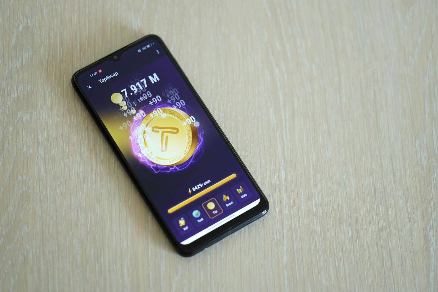 KYIV, UKRAINE - APRIL 20, 2024 Tap Swap telegram bot on smartphone screen. Tap Swap is a viral Telegram based crypto game for earn tokens by managing virtual crypto exchange photo