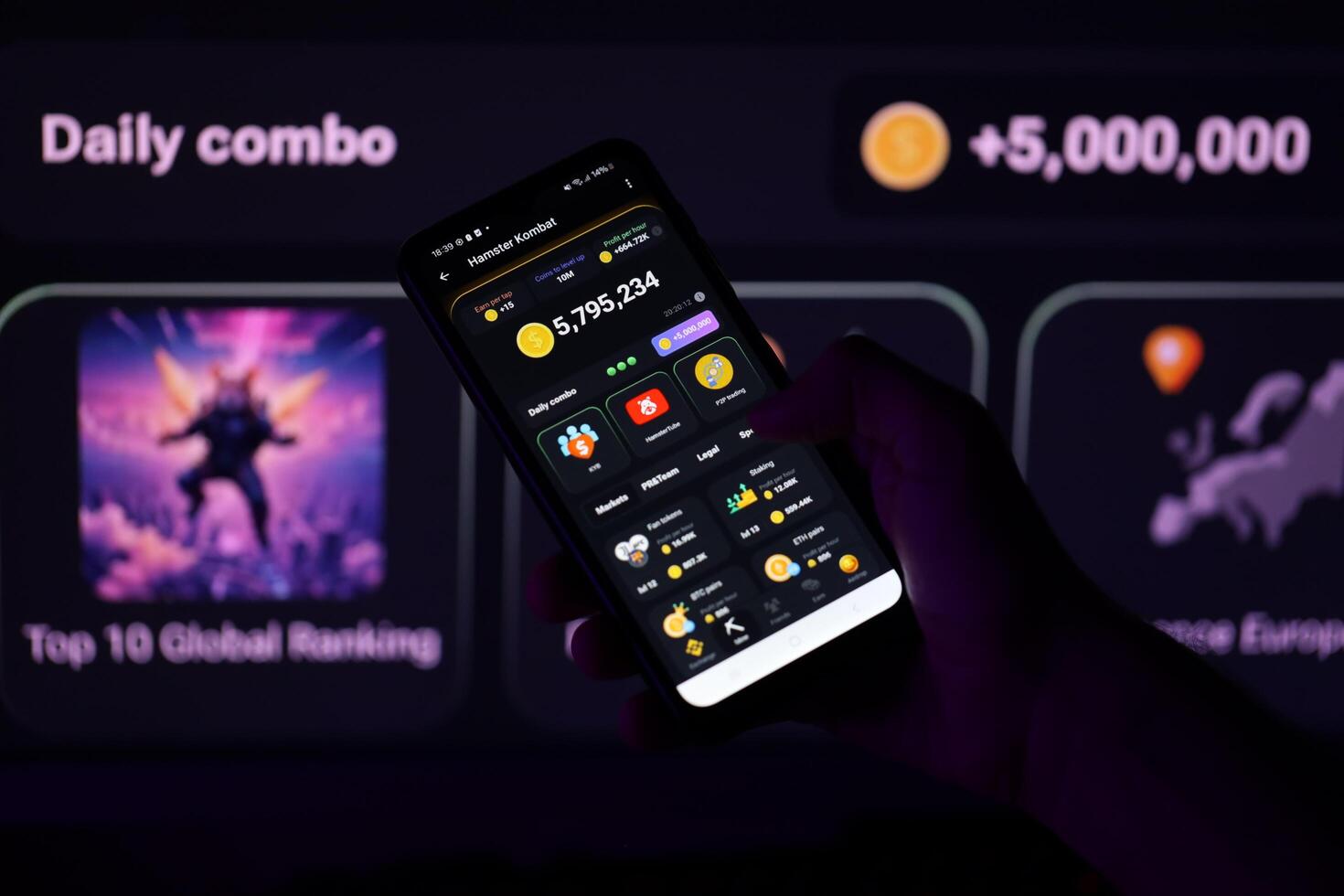 KYIV, UKRAINE - APRIL 20, 2024 Hamster Kombat telegram bot on smartphone screen. Hamster Kombat is a viral Telegram-based crypto game for earn HMSTR tokens by managing virtual crypto exchange photo