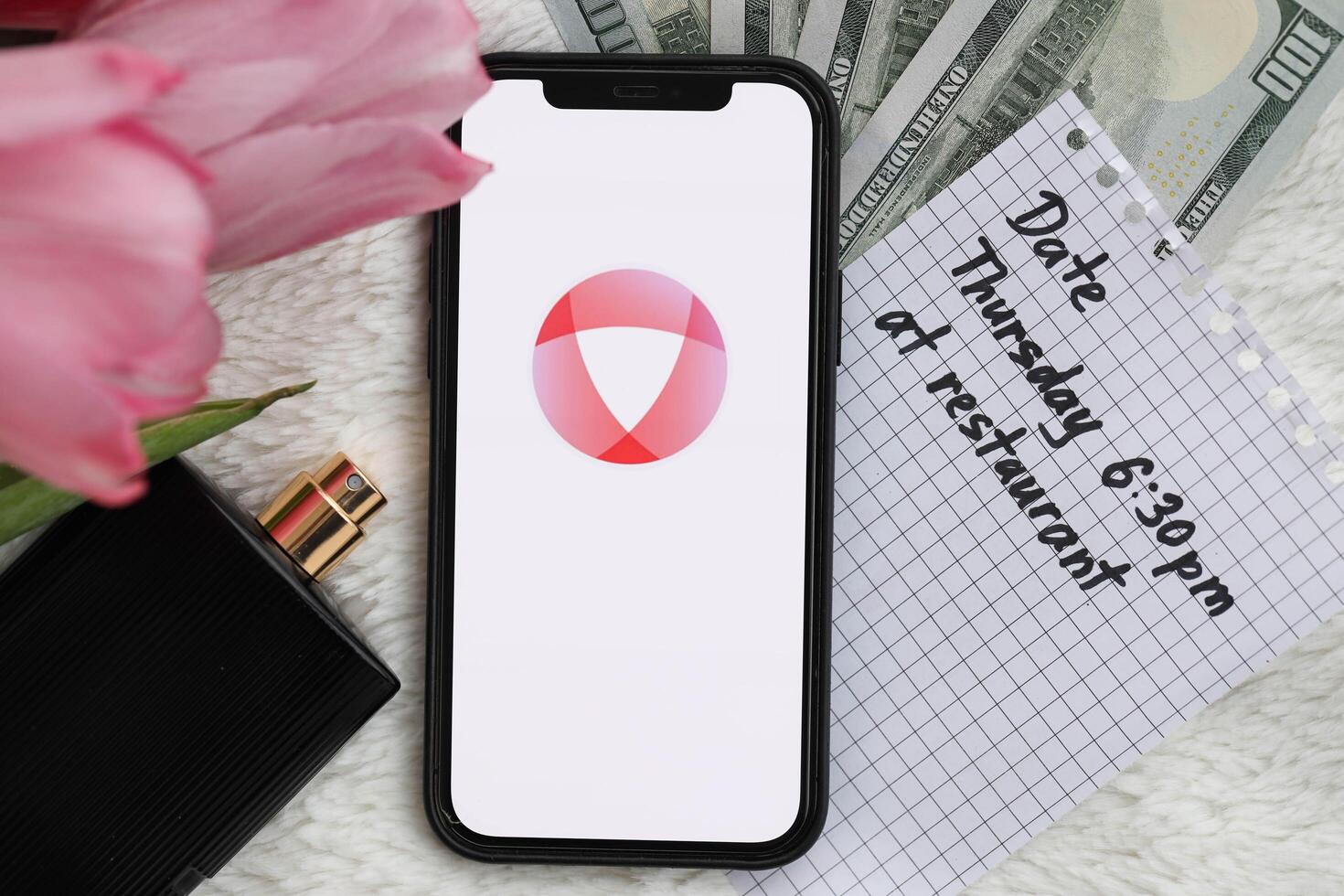 KYIV, UKRAINE - FEBRUARY 23, 2024 Open logo of famous dating website or app on iPhone display photo