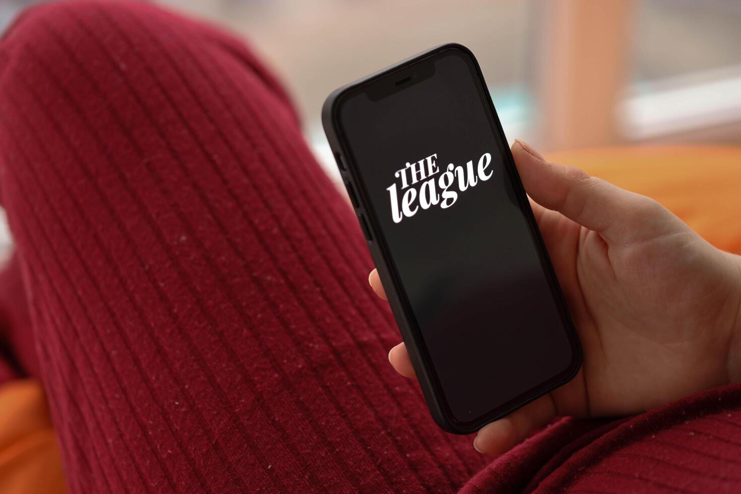 KYIV, UKRAINE - FEBRUARY 23, 2024 The League logo of famous dating website or app on iPhone display photo