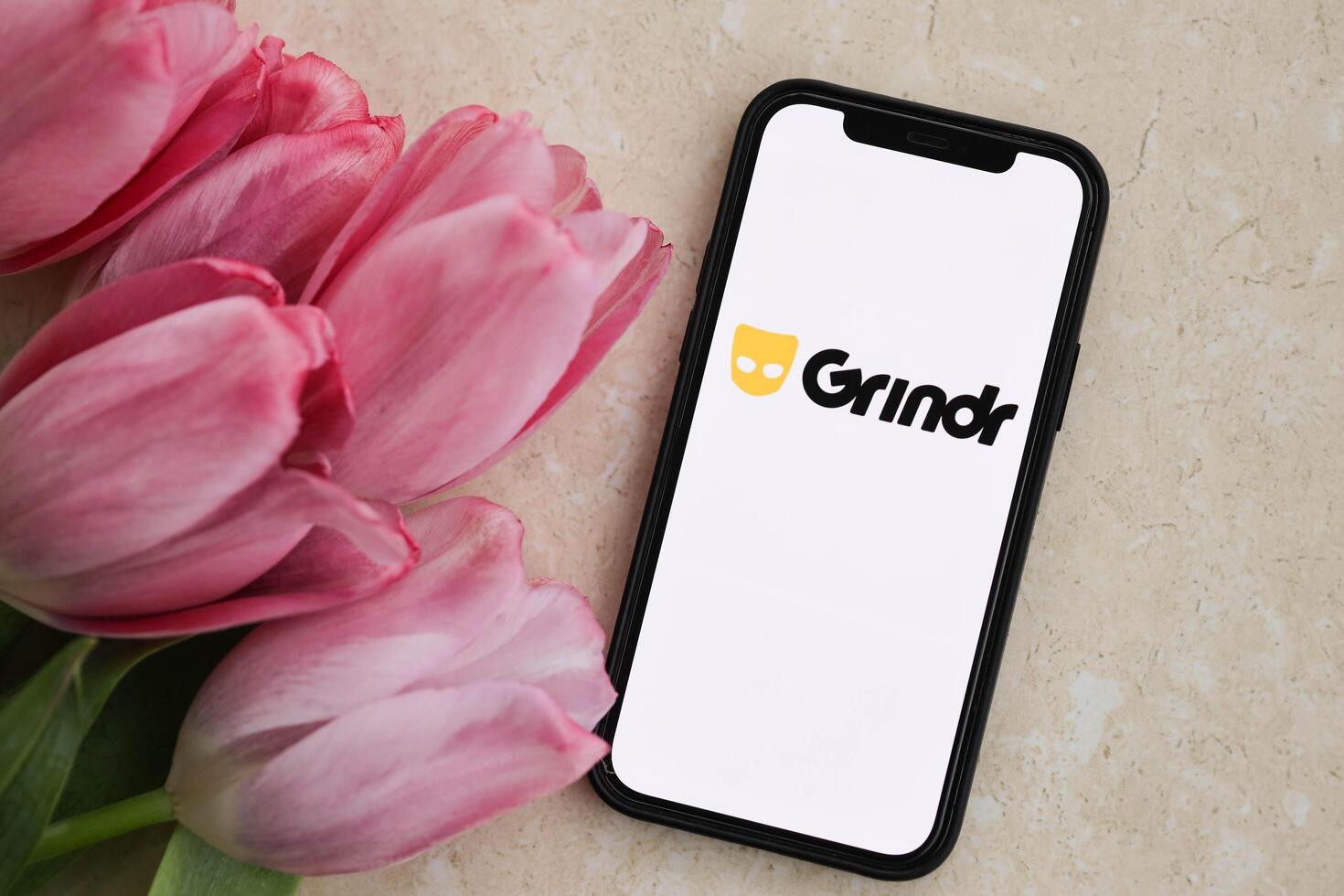 KYIV, UKRAINE - FEBRUARY 23, 2024 Grindr logo of famous dating website or app on iPhone display photo
