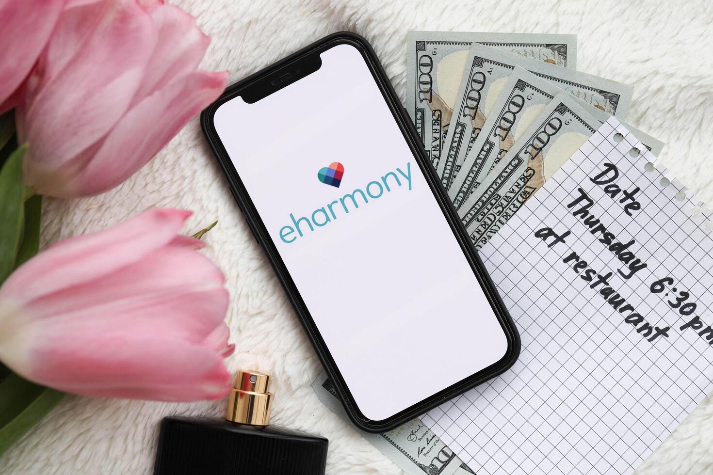 KYIV, UKRAINE - FEBRUARY 23, 2024 Eharmony logo of famous dating website or app on iPhone display photo