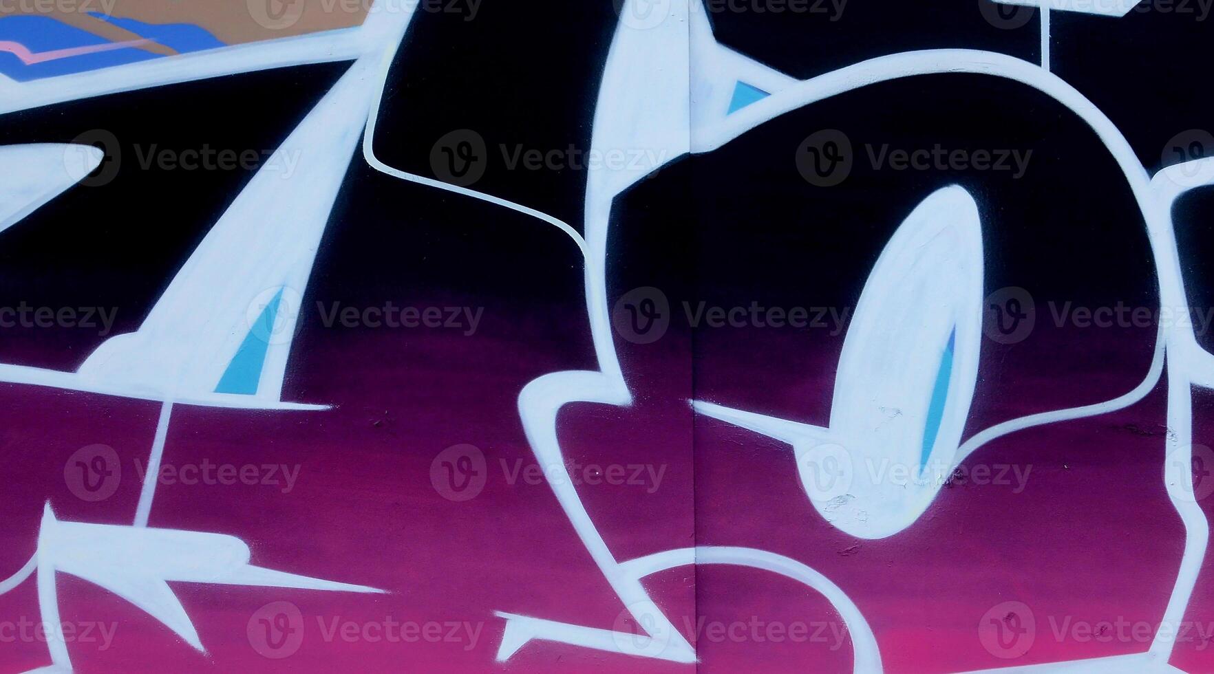 Colorful background of graffiti painting artwork with bright aerosol outlines on wall. Old school street art piece made with aerosol spray paint cans. Contemporary youth culture photo