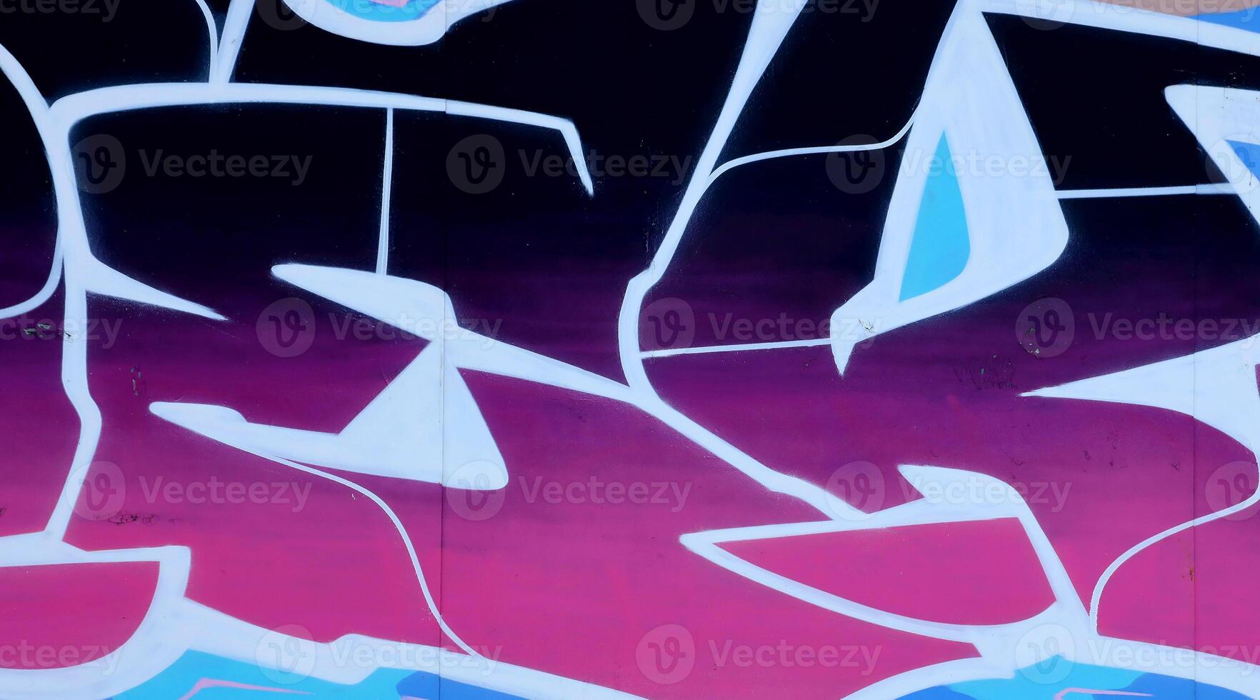 Colorful background of graffiti painting artwork with bright aerosol outlines on wall. Old school street art piece made with aerosol spray paint cans. Contemporary youth culture photo