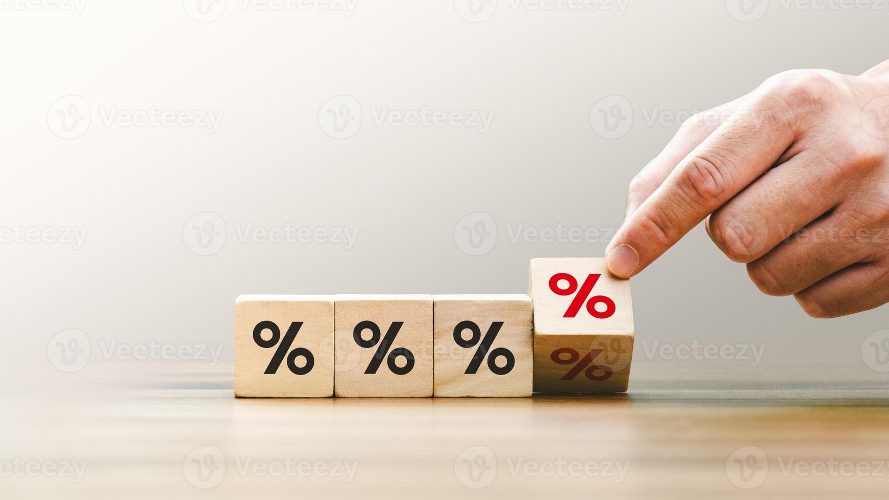 Hand Stacking Wooden Blocks with Percentage Signs, Representing Financial Growth, Interest Rates, and Investment Concepts in a Minimalist Setting, Emphasizing Economic Strategy and Profit Management photo