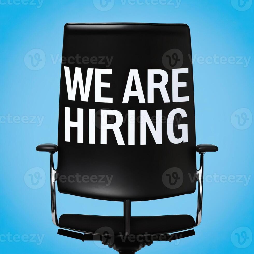Office chair with We Are Hiring text on blue Background, symbolizing job opportunities and recruitment. photo