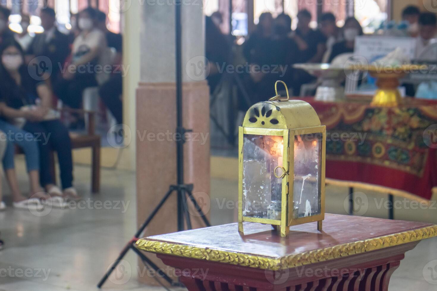 Funeral lamps in glass cabinets use natural energy, oil, and candles. photo
