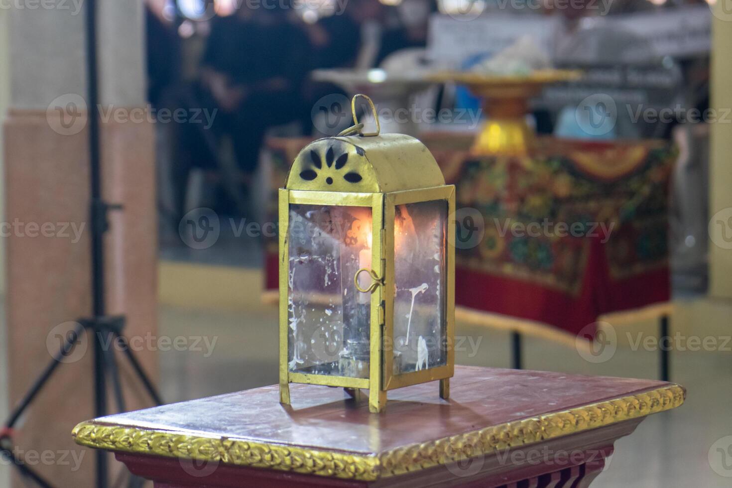 Funeral lamps in glass cabinets use natural energy, oil, and candles. photo