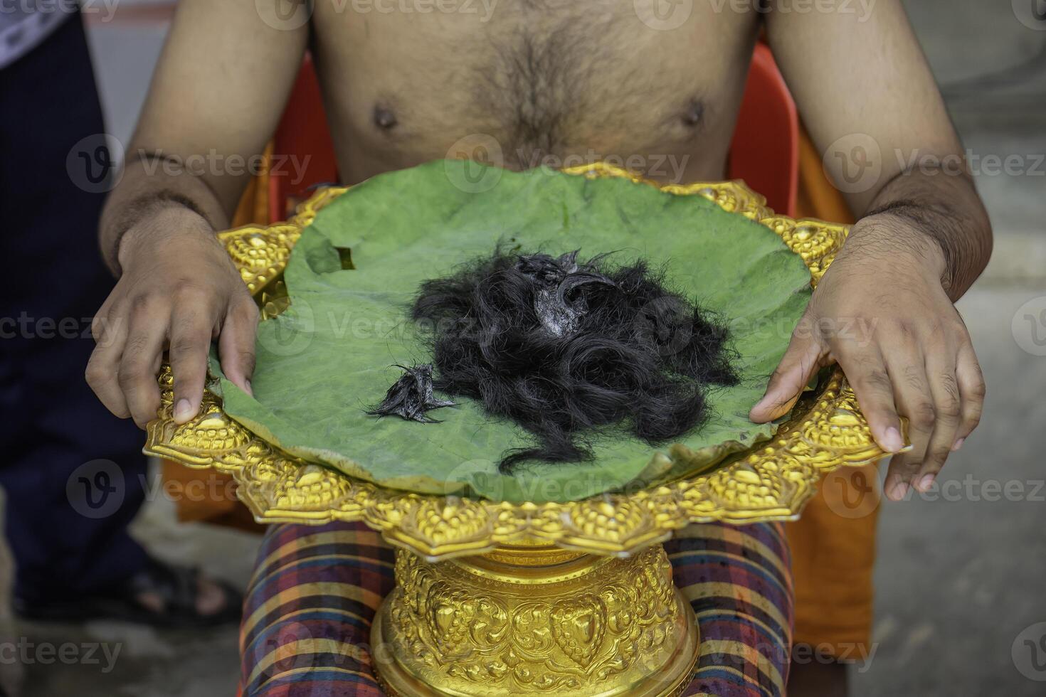 green lotus leaf and clipped hair used in Buddhist rituals in Asia photo