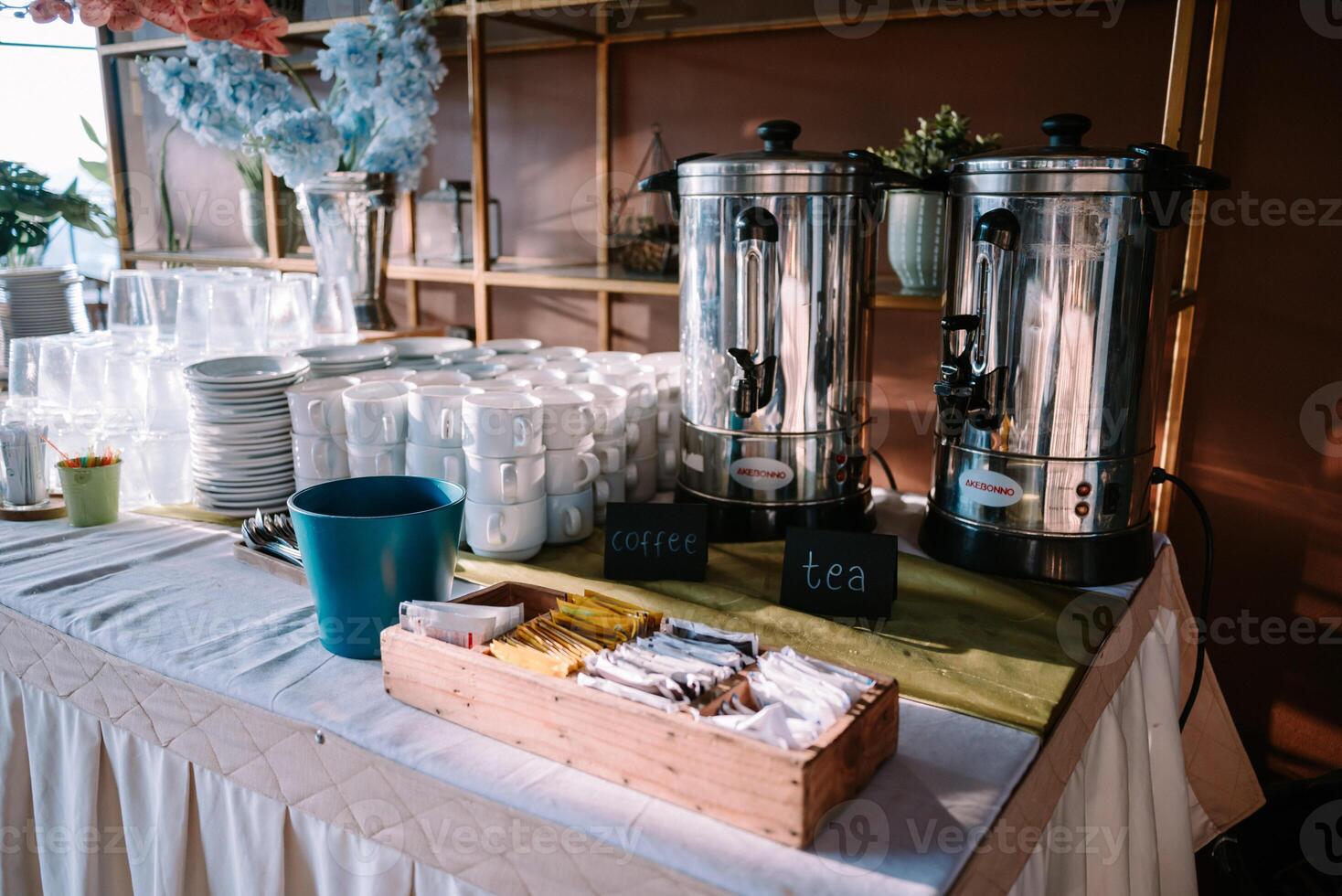 Iron thermoses of coffee and tea with cups and sugar sachets, perfect for a warm gathering photo