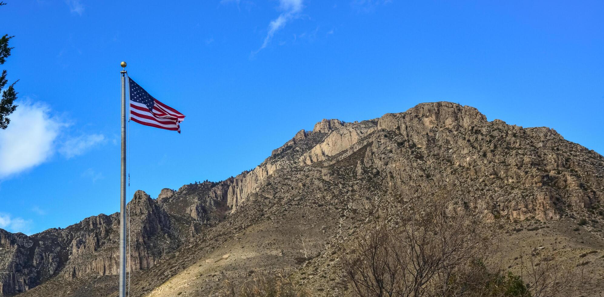 American flag against a blue sky in the territory of a visit center in a park in New Mexico photo