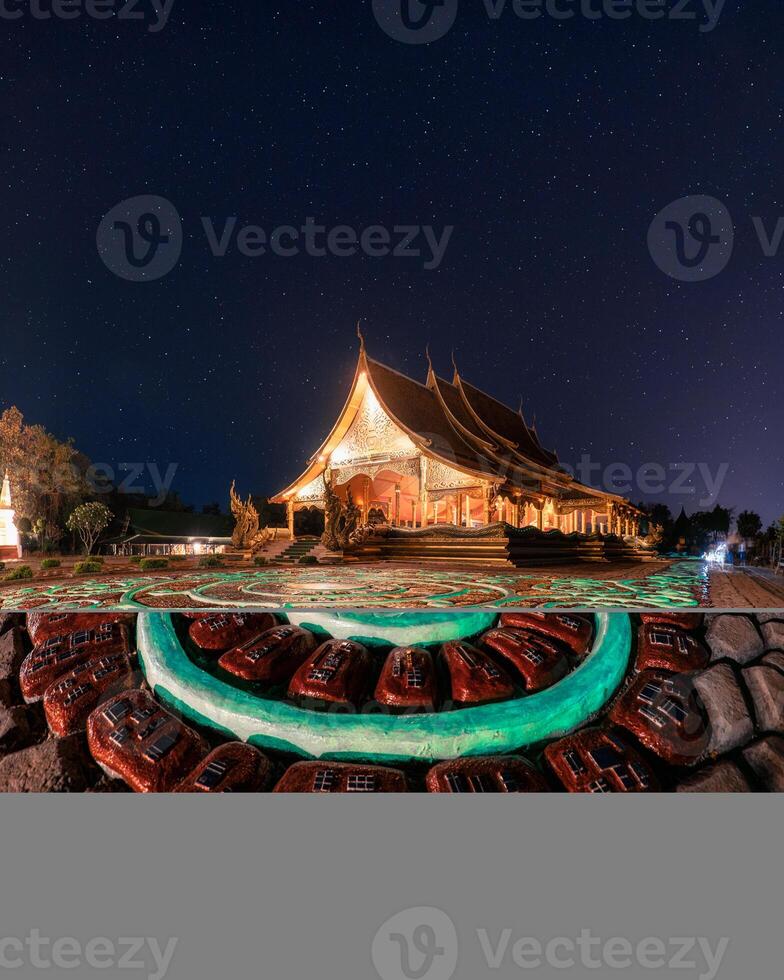 Wat Sirindhorn Wararam Temple or Wat Phu Prao with illuminated church and glowing sculpture in the night at Ubon Ratchathani photo