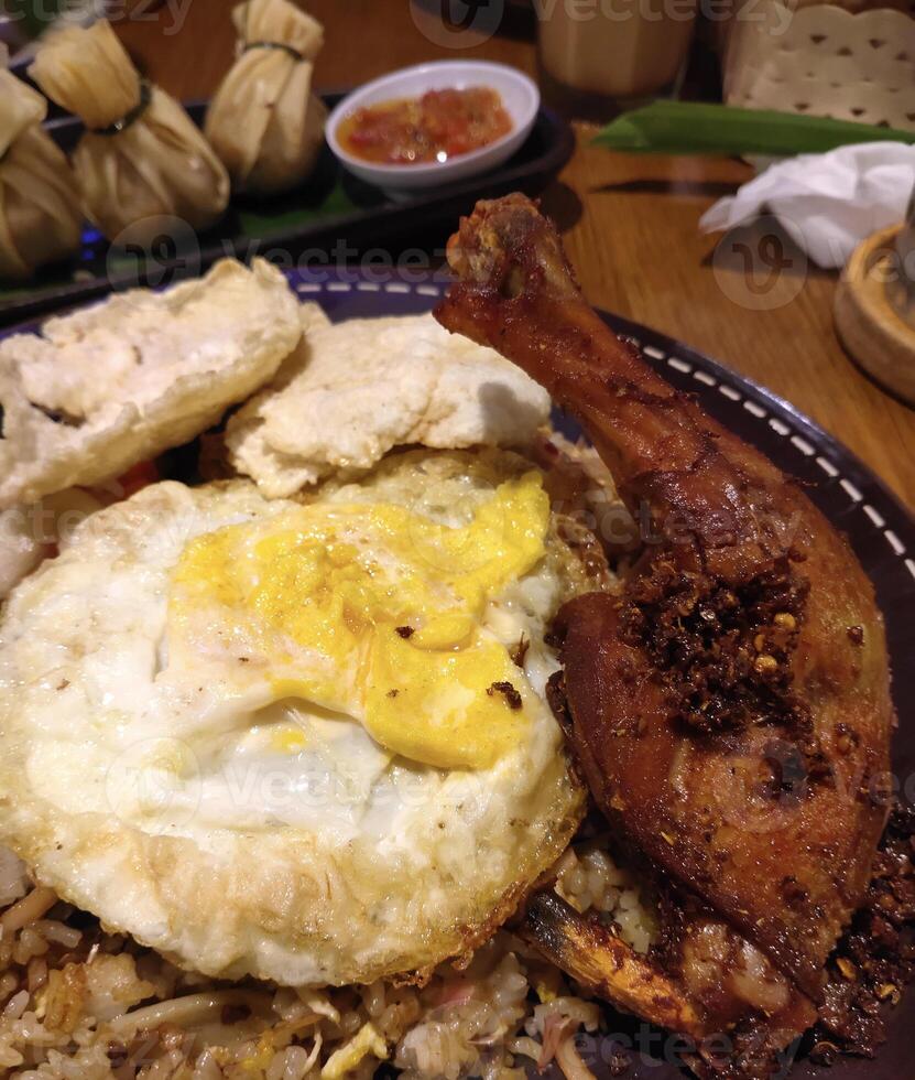 Nasi Goreng Kecombrang or Kecombrang Fried Rice with fried egg and fried chicken, a typical Balinese food, Indonesia photo