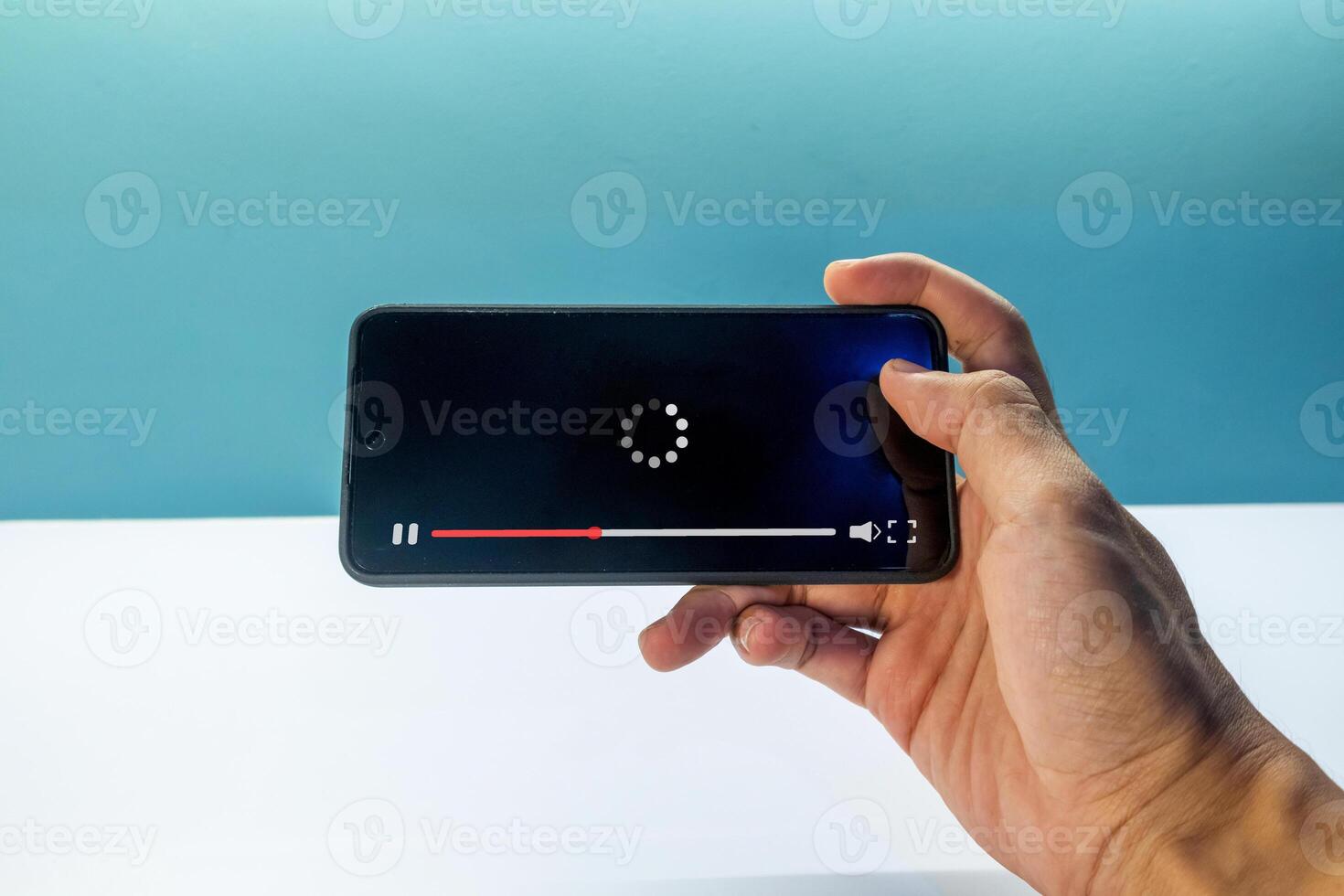 A man watching a movie via a smart phone. Streaming on internet concept. photo
