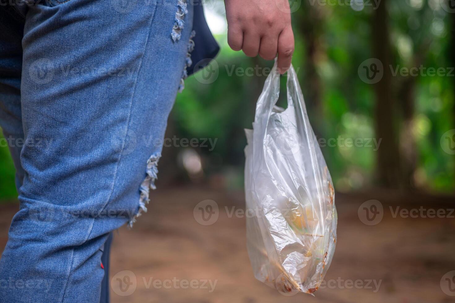 Conservation of natural tourist attractions, Sustainable tourism, Tourists are collecting plastic waste from natural attractions to put in bin photo